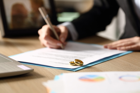 A lawyer fills out divorce papers