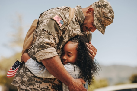military dad hugging daughter